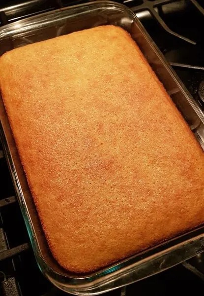 Glass baking dish filled with freshly baked sweet cornbread, golden and cake-soft – sweet cornbread recipe