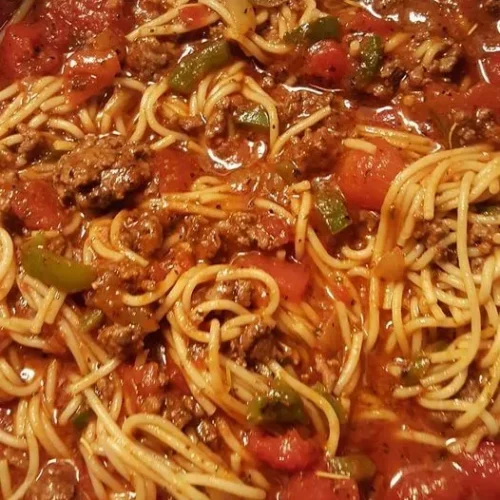 Close-up of perfectly al dente spaghetti topped with meat sauce