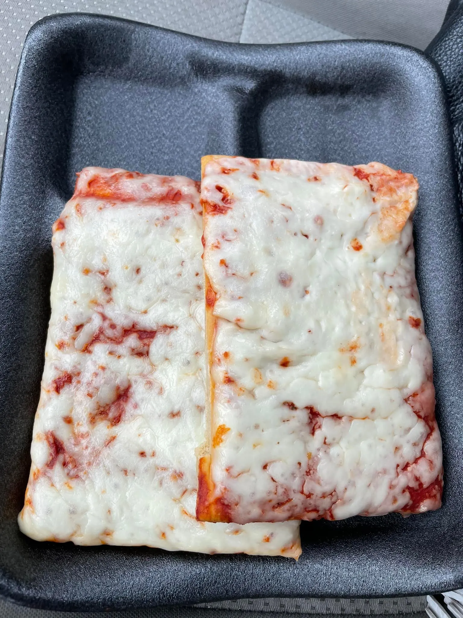 Square-cut pizza rectangles with biscuit-style crust and melted cheese.
