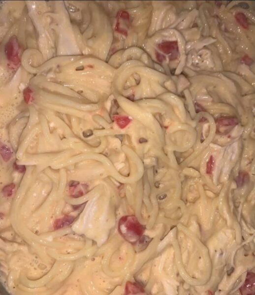 Cheesy chicken spaghetti casserole in a baking dish, golden and bubbly