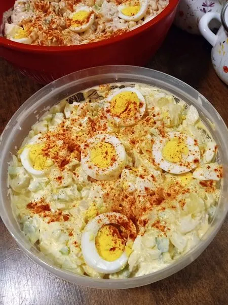 Classic potato salad with chopped eggs and sprinkled paprika.