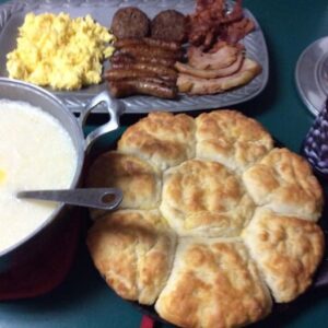 Big, fluffy cathead biscuits in a cast iron skillet, fresh from the oven – classic old fashioned lard biscuits recipe
