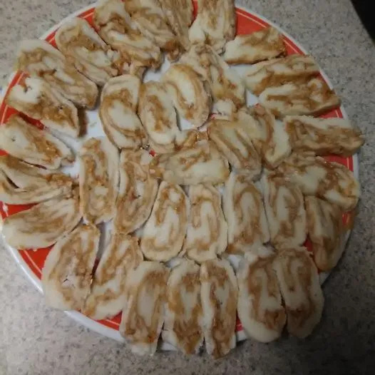 Swirled potato candy slices arranged on a festive plate.