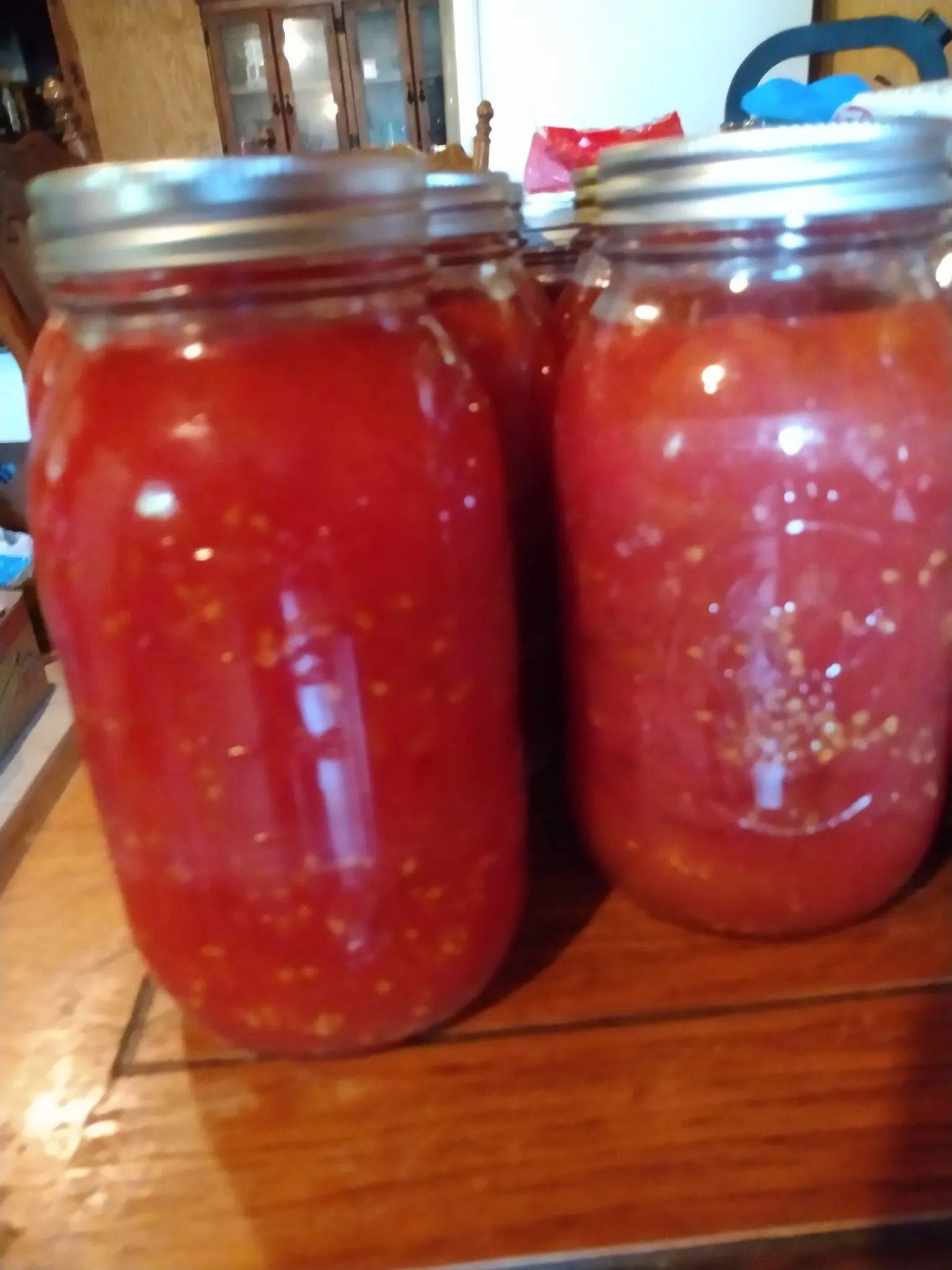 Homemade tomato soup simmering in a pot; creamy tomato soup served in a bowl with basil.