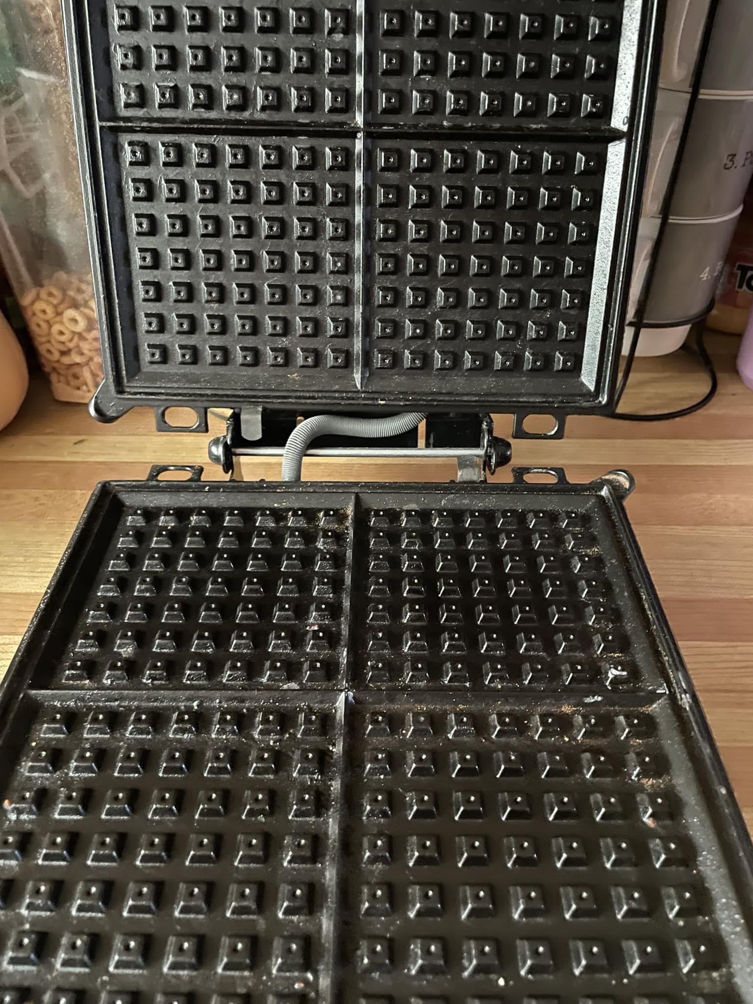 A waffle press used to shape dough for the Grandma Cookies recipe