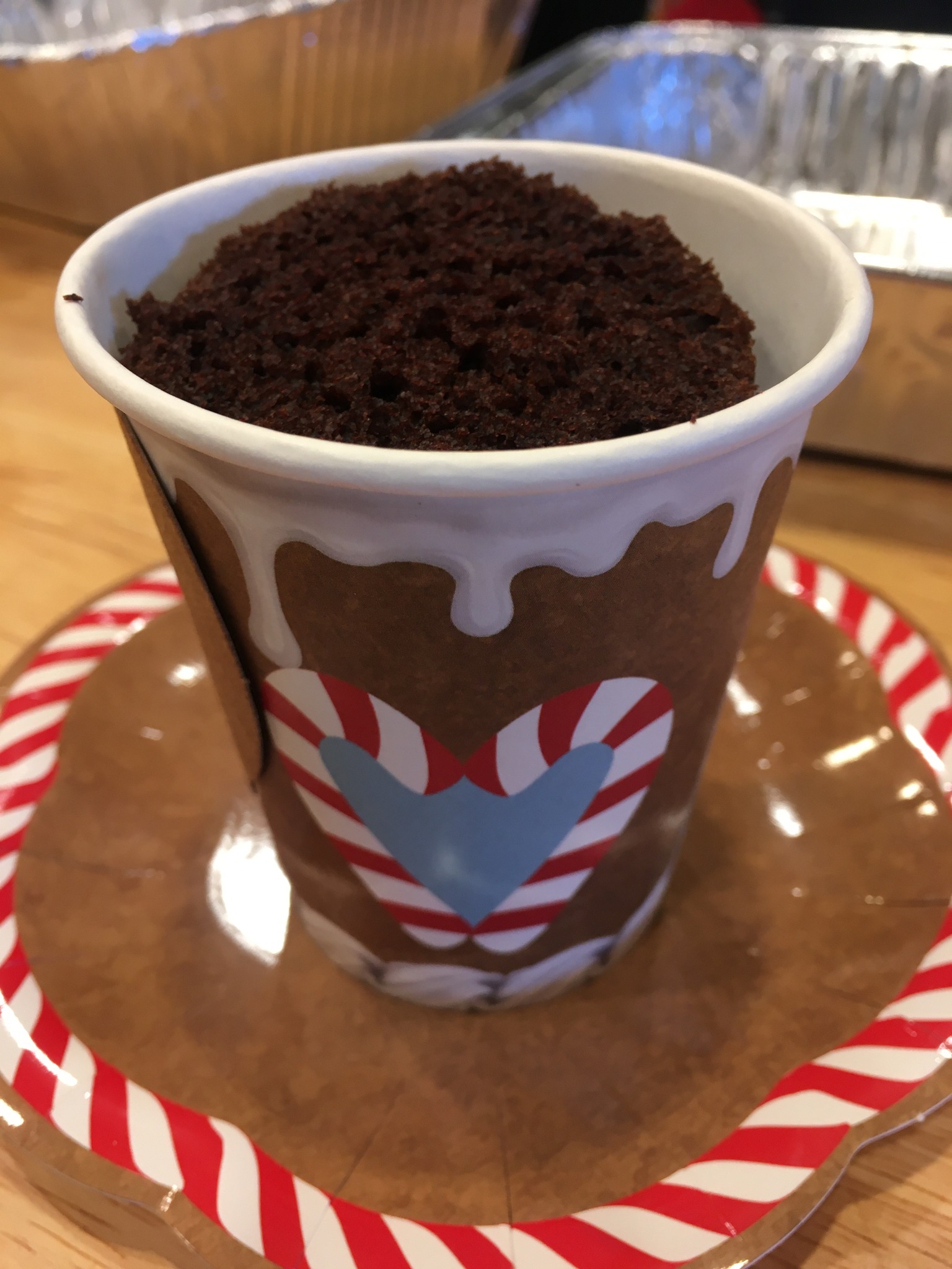 A chocolate cupcake inside a festive cup