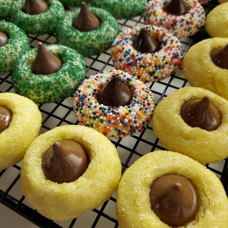 Kiss Cookies decorated with green, rainbow, and yellow sprinkles, topped with Hershey’s Kisses.