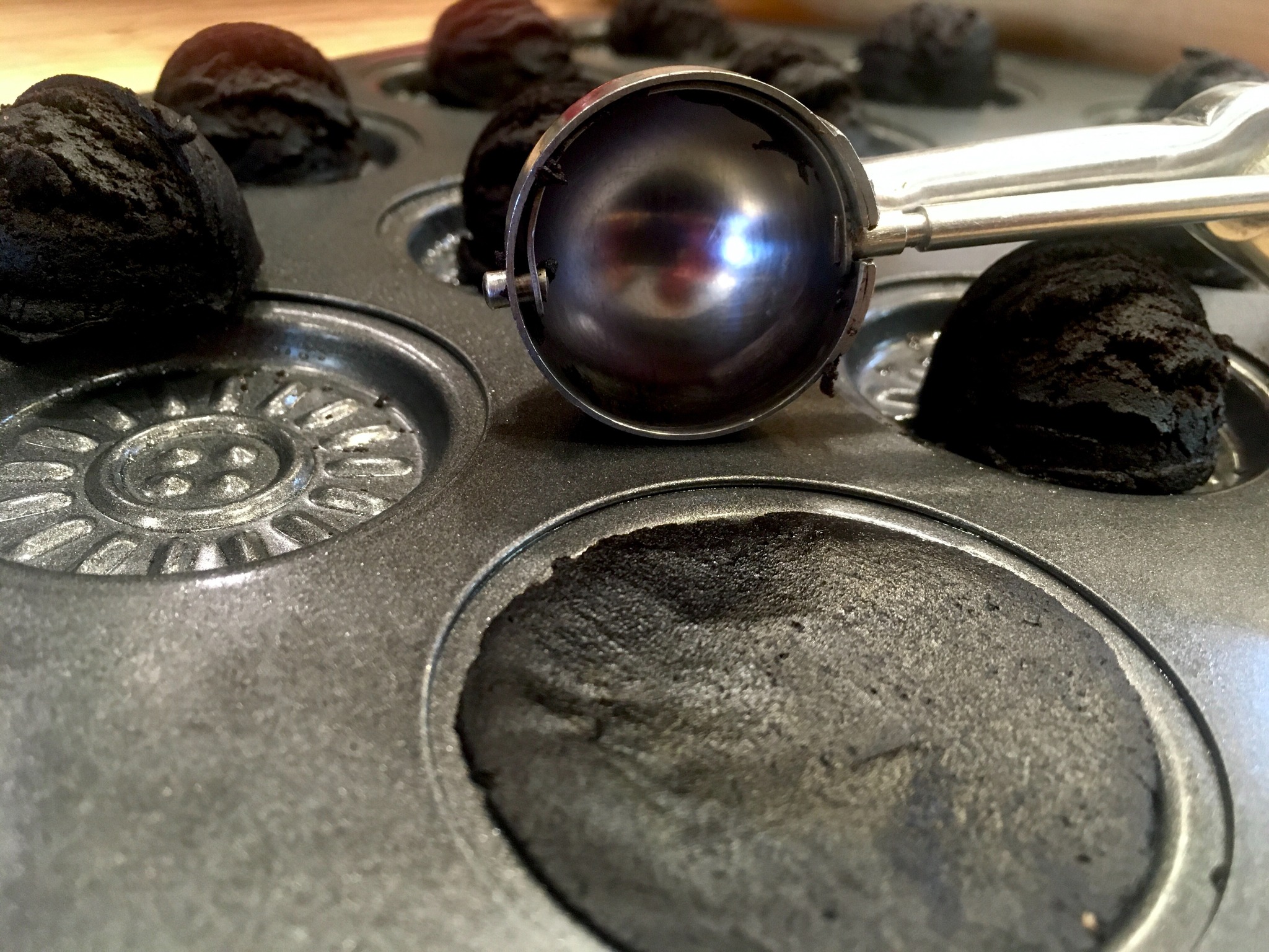 Black cacao cookie dough pressed into a baking mold