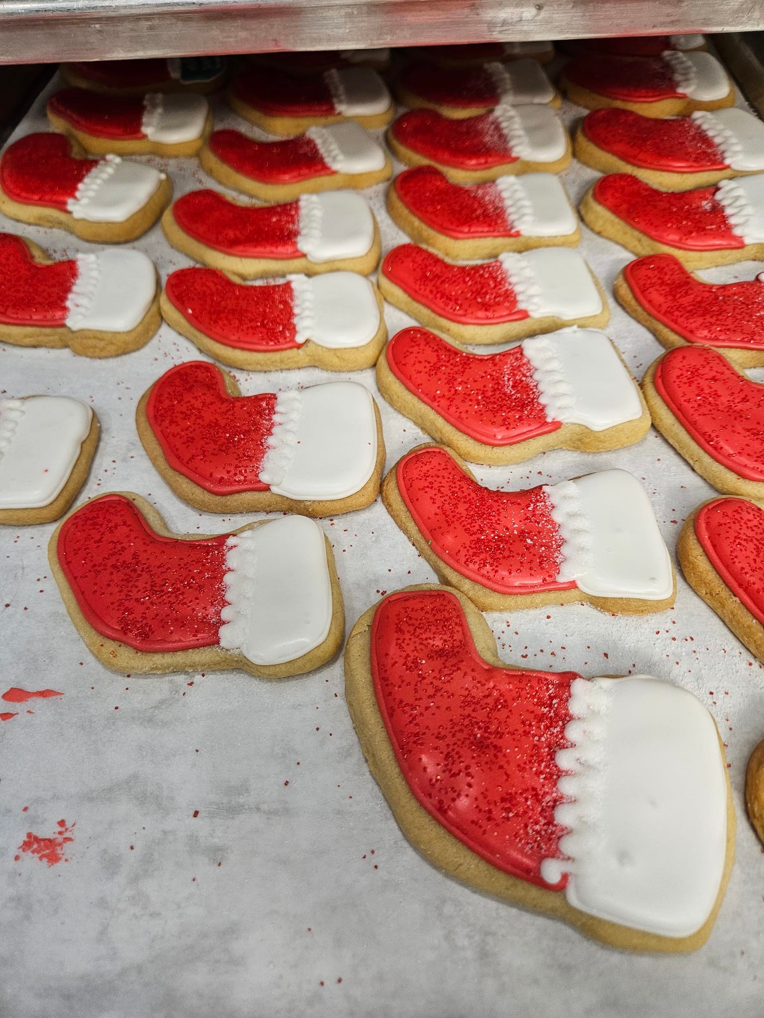 Stocking-shaped sugar cookies decorated with bright red and white icing