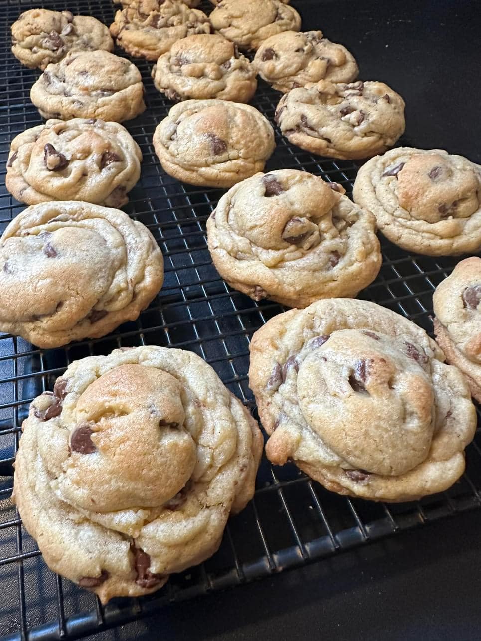 Freshly baked soft and chewy chocolate chip cookies cooling on a wire rack.