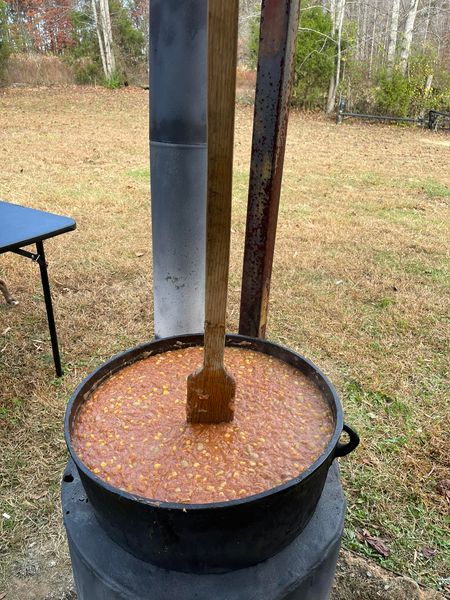 Big batch Brunswick stew cooking outdoors in a large pot, perfect for feeding a crowd at gatherings