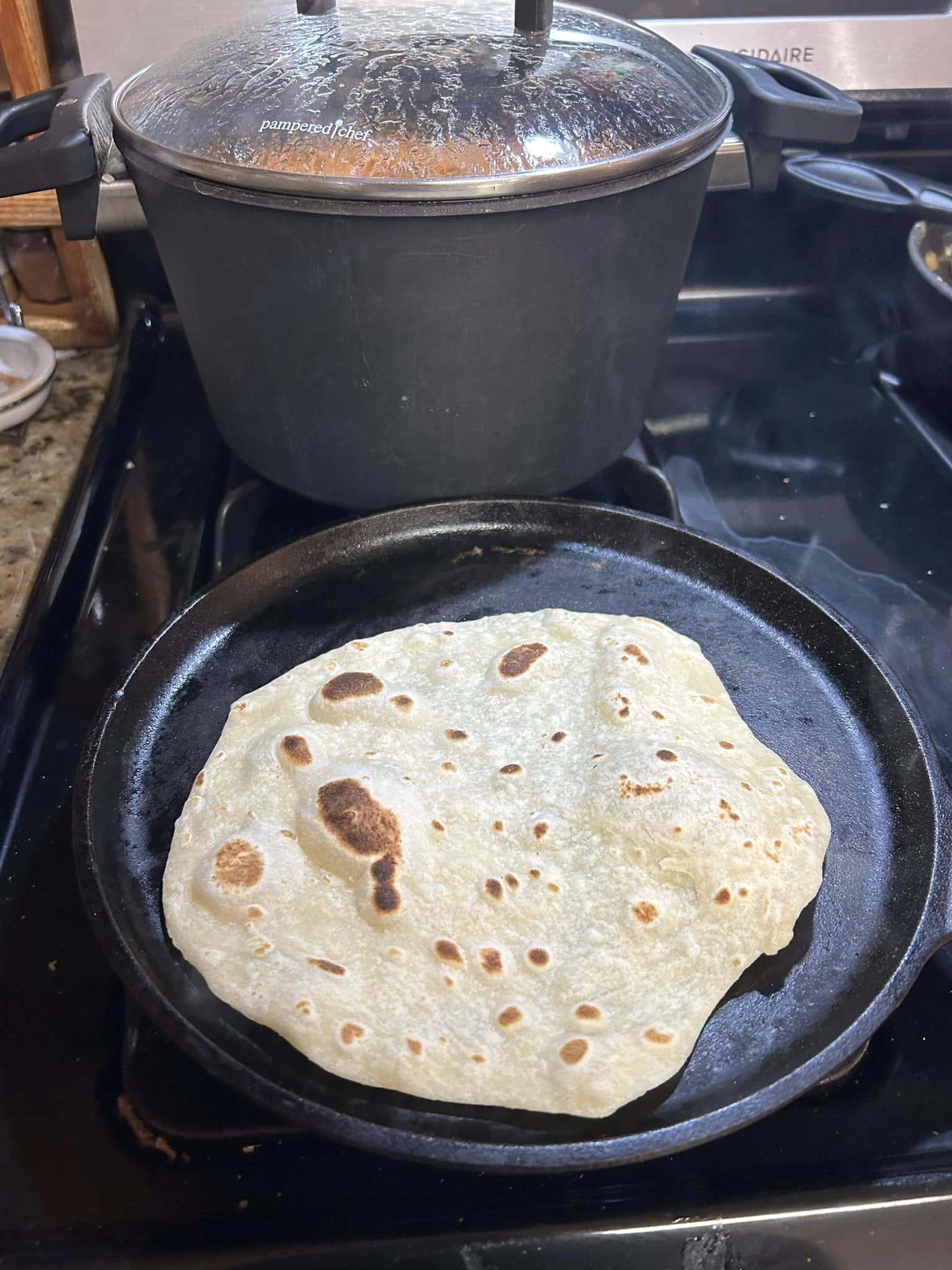 (Tortilla on the comal, uncooked