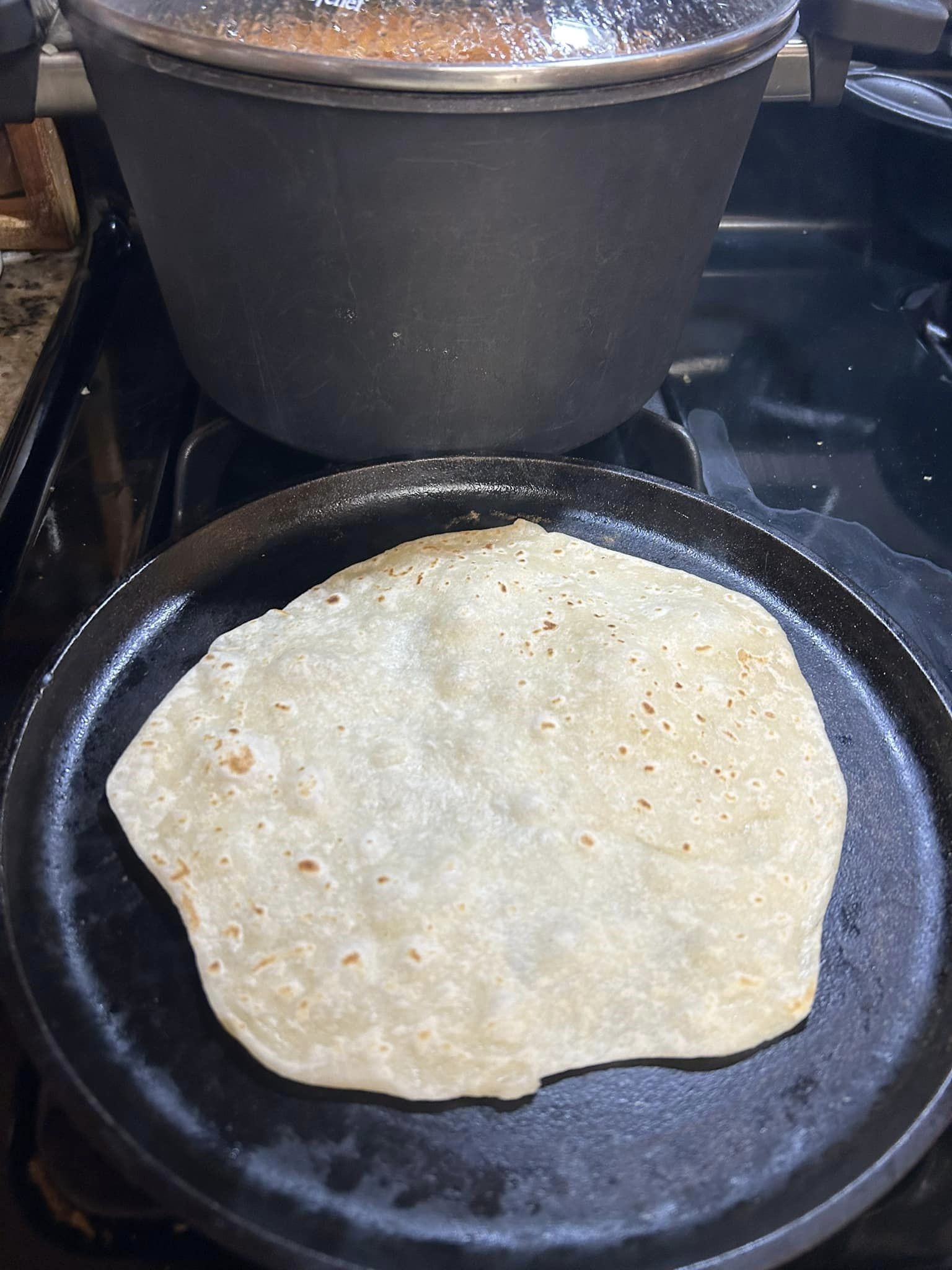 (Tortilla on the comal, uncooked