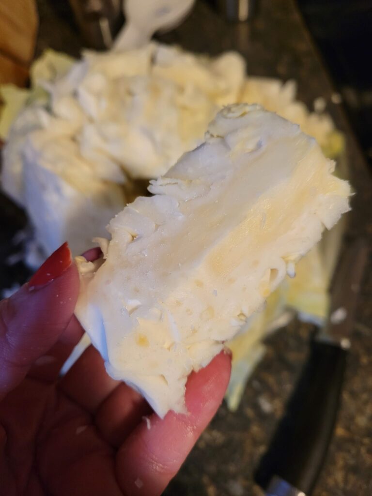 A freshly cut cabbage core held in hand, ready to be salted and enjoyed