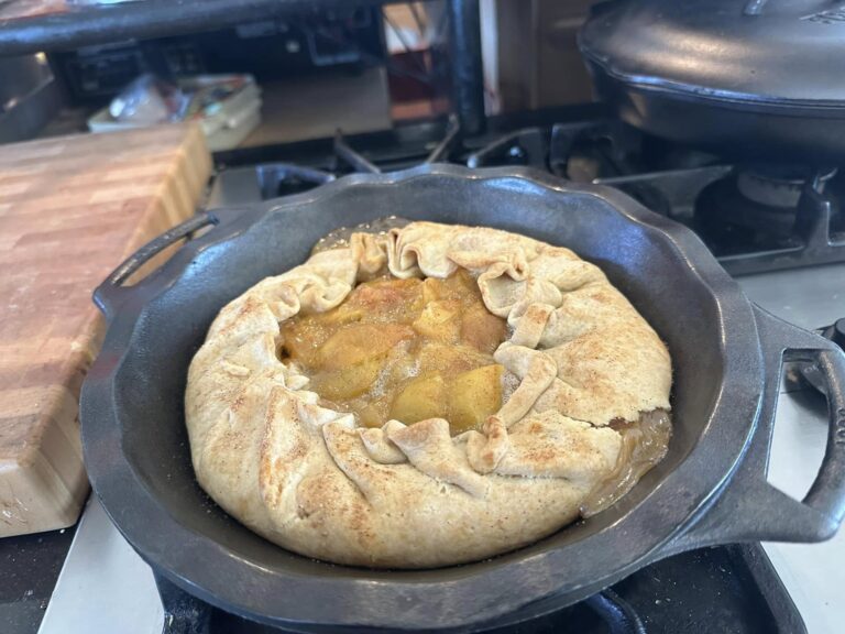 A golden-brown peach galette with juicy peaches and cinnamon sugar, baked to perfection