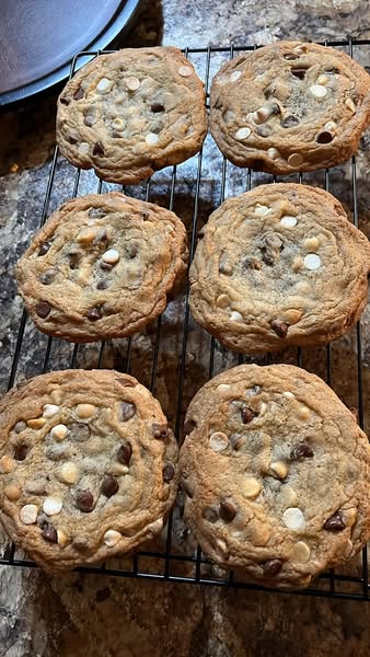 Golden-brown chocolate chip and cream cheese cookies fresh out of the oven on a baking sheet