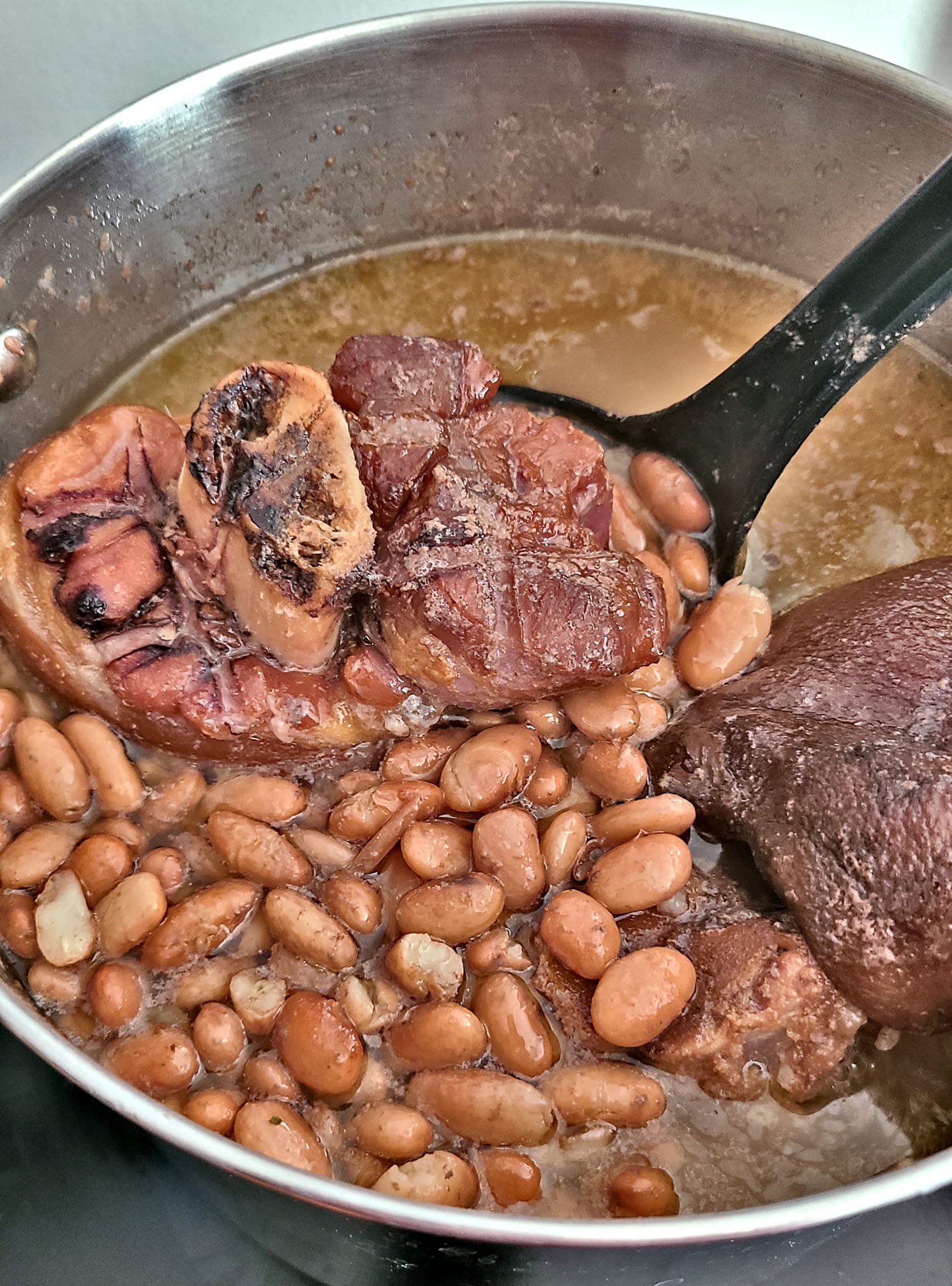 A large pot of Southern pinto beans with ham hocks, slow-cooked to perfection with rich, smoky flavor