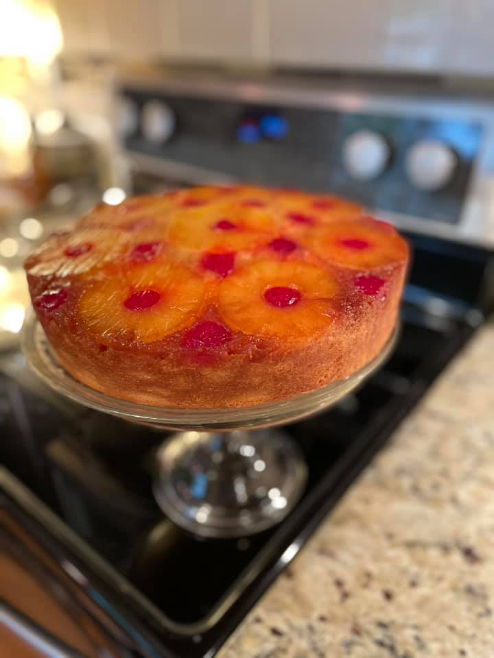 Golden brown pineapple upside down cake with glossy caramelized fruit and a moist, fluffy cake base