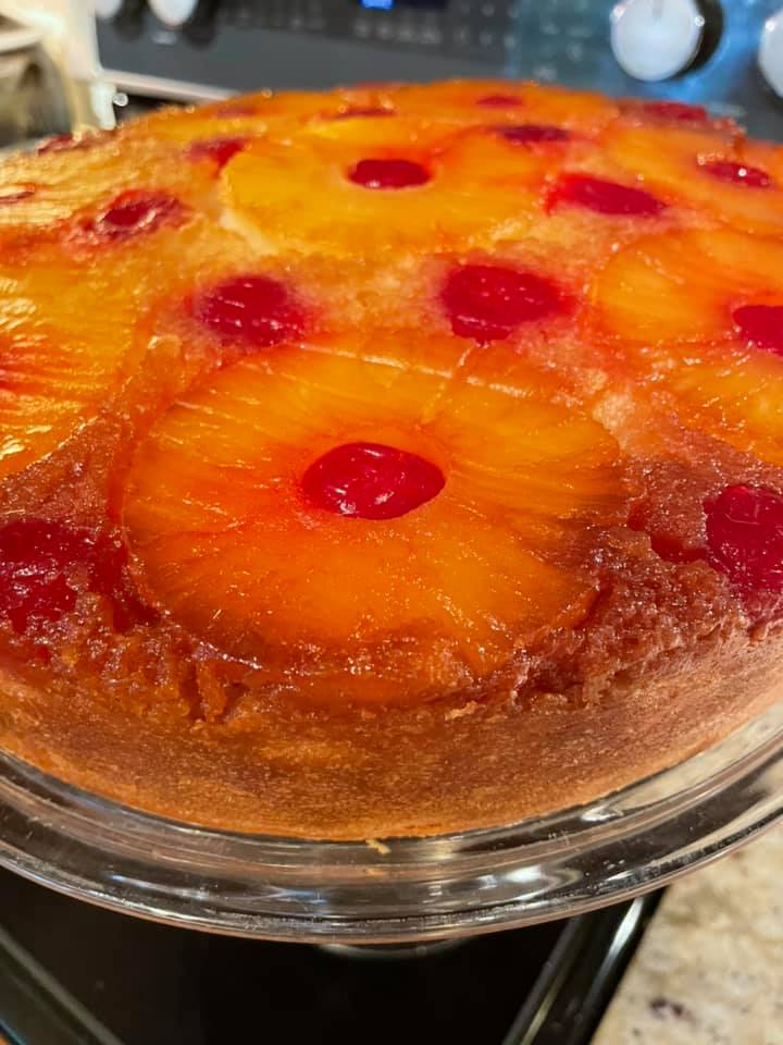 Homemade pineapple upside down cake made with cake flour, featuring caramelized pineapple rings and cherries.