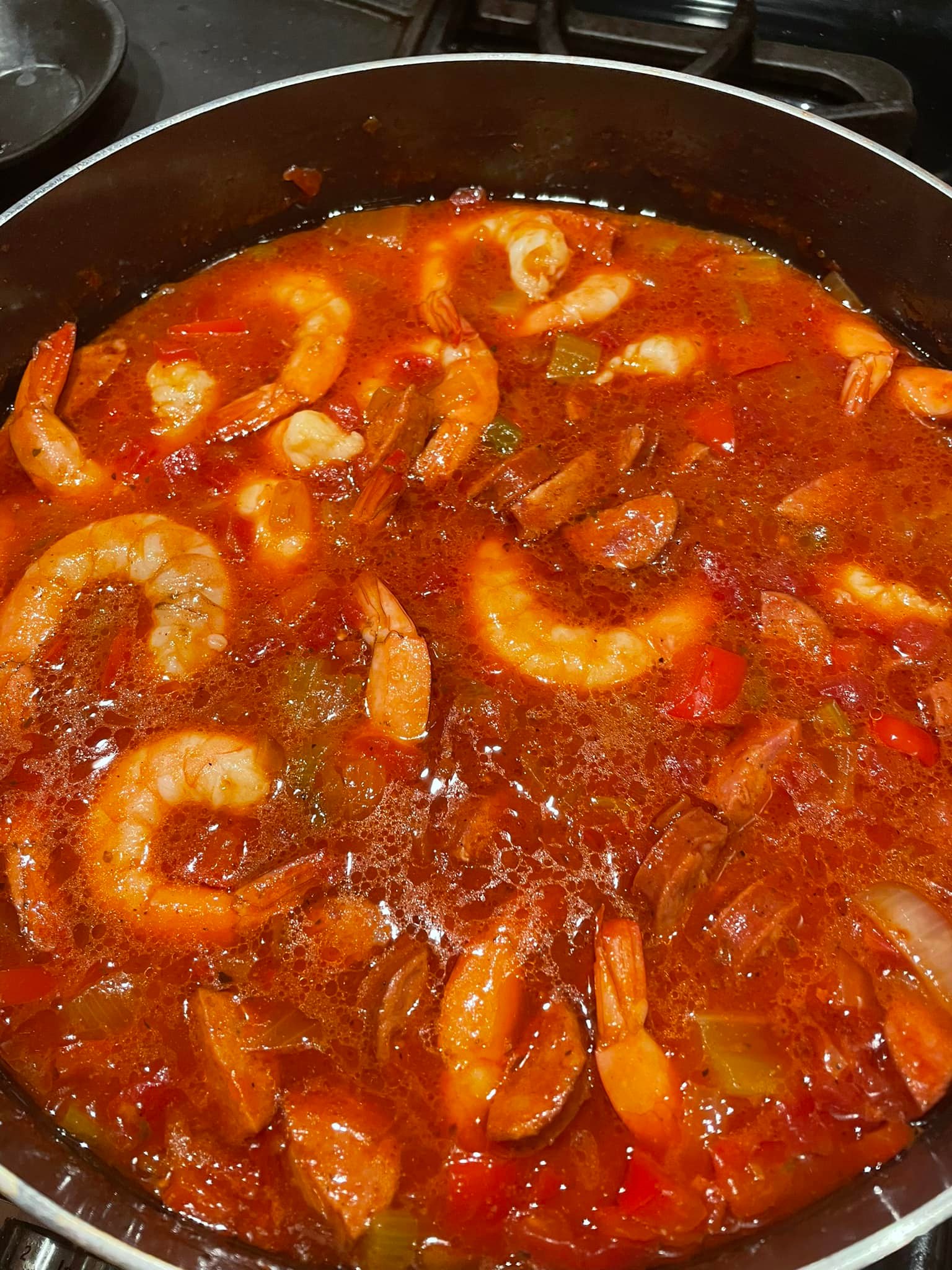 "A bowl of South Carolina Creole with shrimp, boudin, and rice, served with French bread.