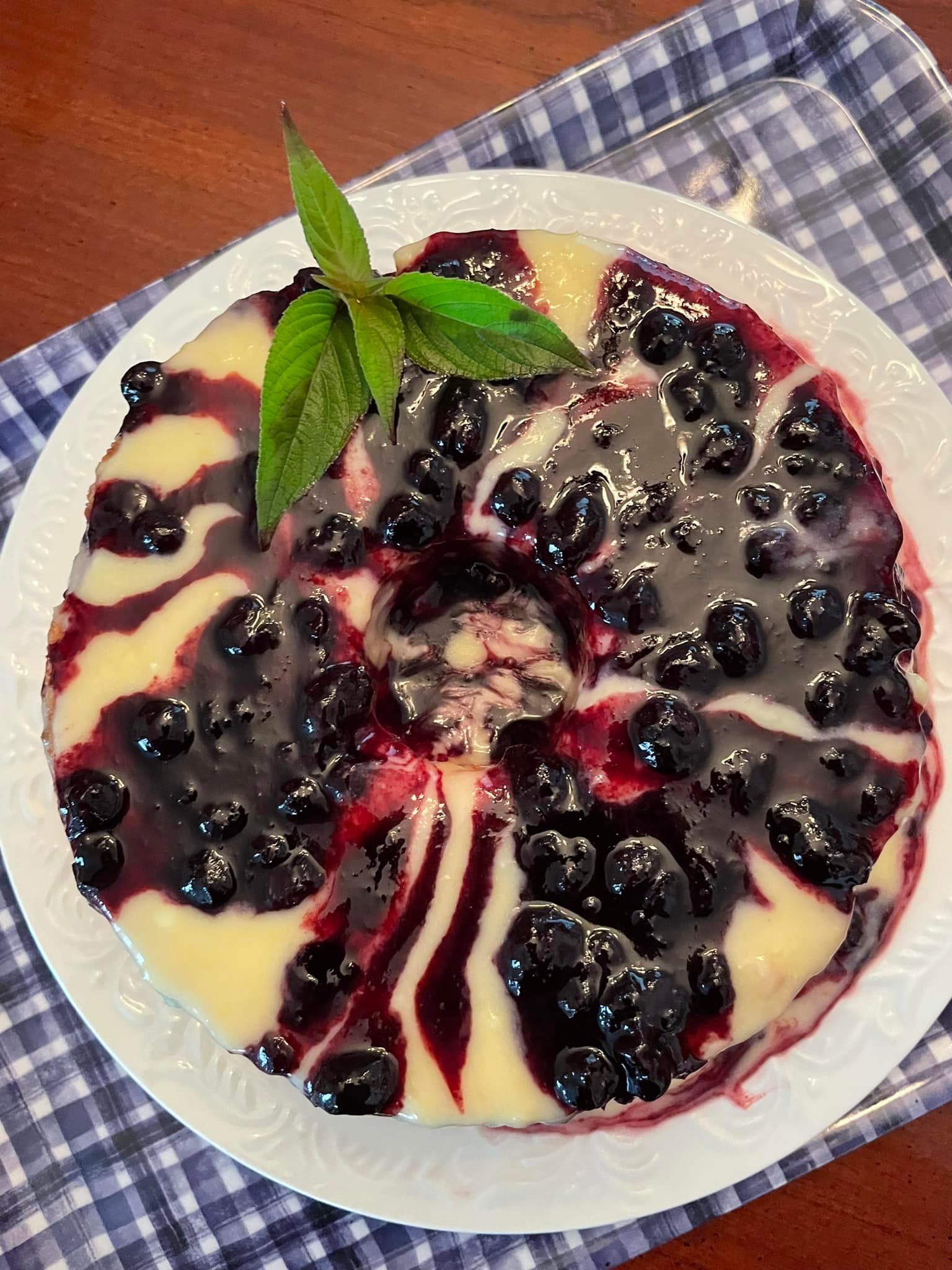 Angel Food Cake drizzled with lemon curd and blueberry compote, garnished with fresh mint