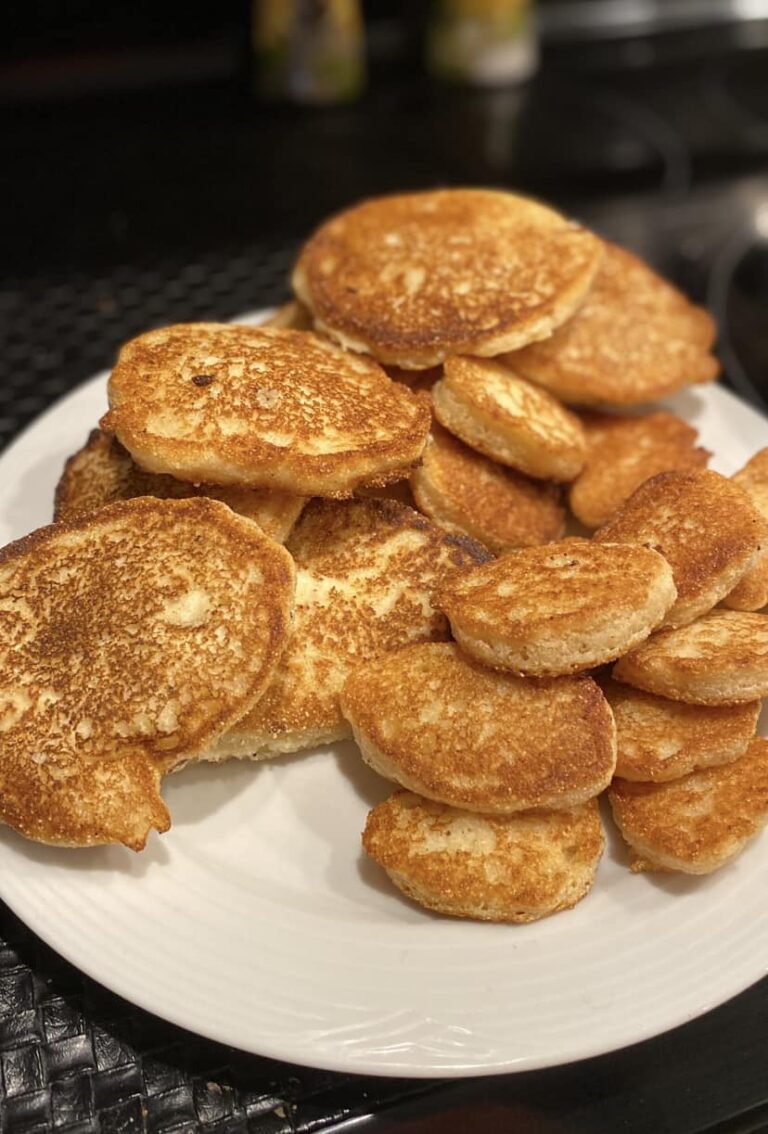 A plate of crispy golden fried cornbread hoecakes, perfect for pairing with any meal.