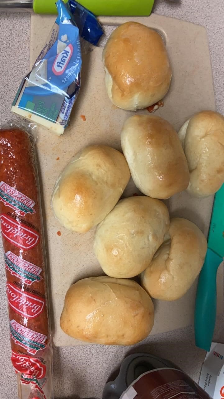 A plate of golden brown pepperoni rolls, fresh from the oven and ready to enjoy.