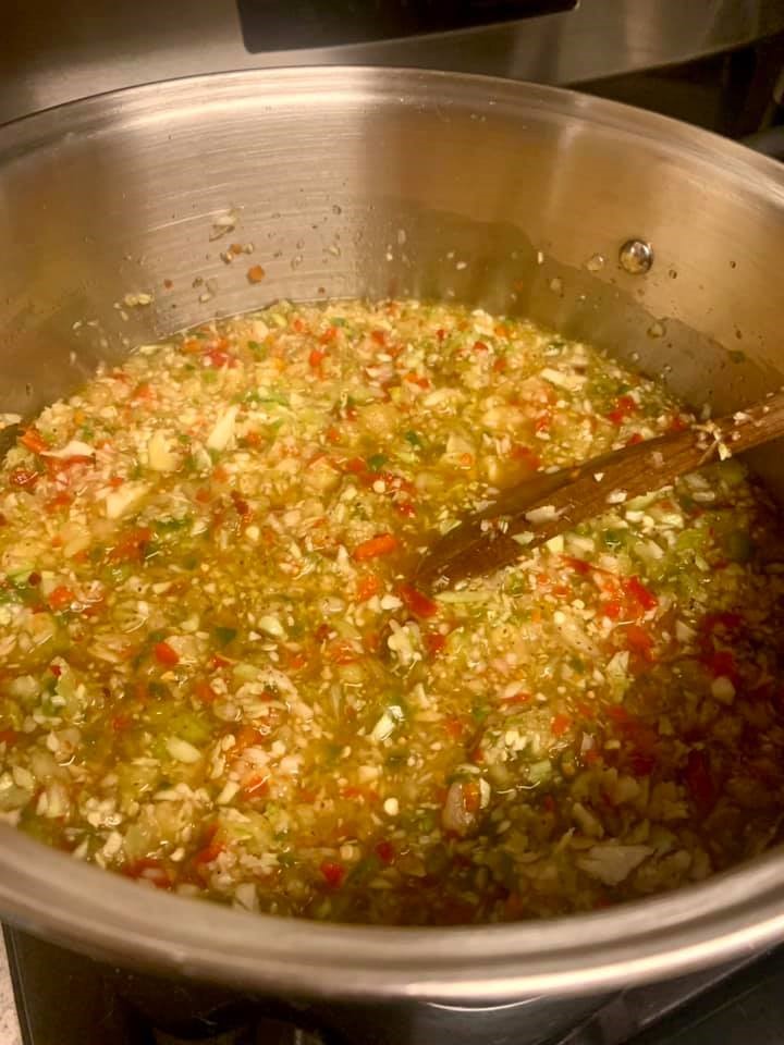 A pot of Southern chow chow simmering with spices and vinegar on the stovetop