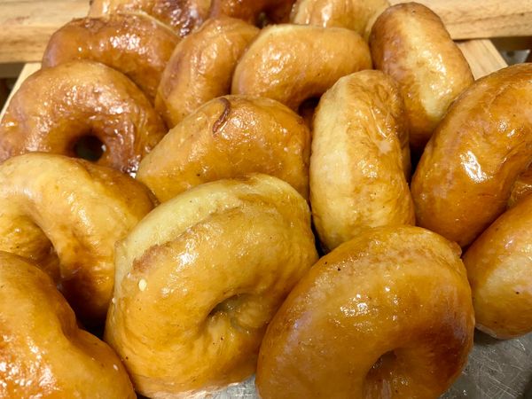 Close-up of golden homemade donuts, coated in a shiny glaze