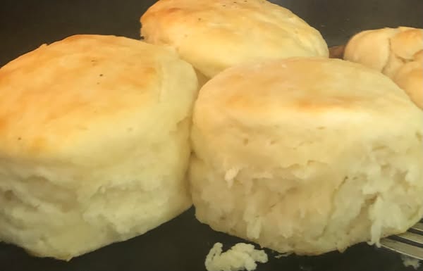 Golden, fluffy homemade biscuits fresh out of the oven, perfect for pairing with chocolate gravy.