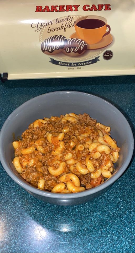 A warm bowl of homemade goulash with macaroni, ground beef, and tomato sauce, served fresh.