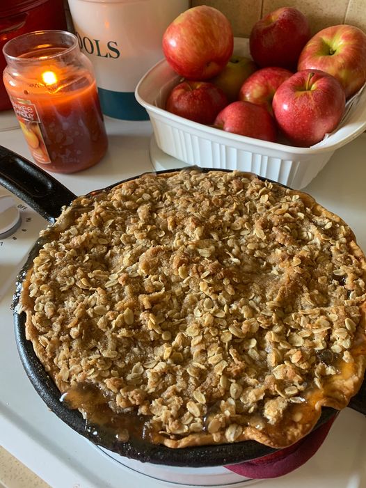 A golden, homemade apple crisp with a buttery crust and oat topping, fresh from the oven.