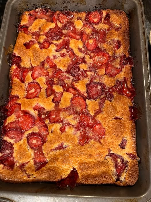 Freshly baked strawberry cobbler with a golden crust and bubbling strawberry filling