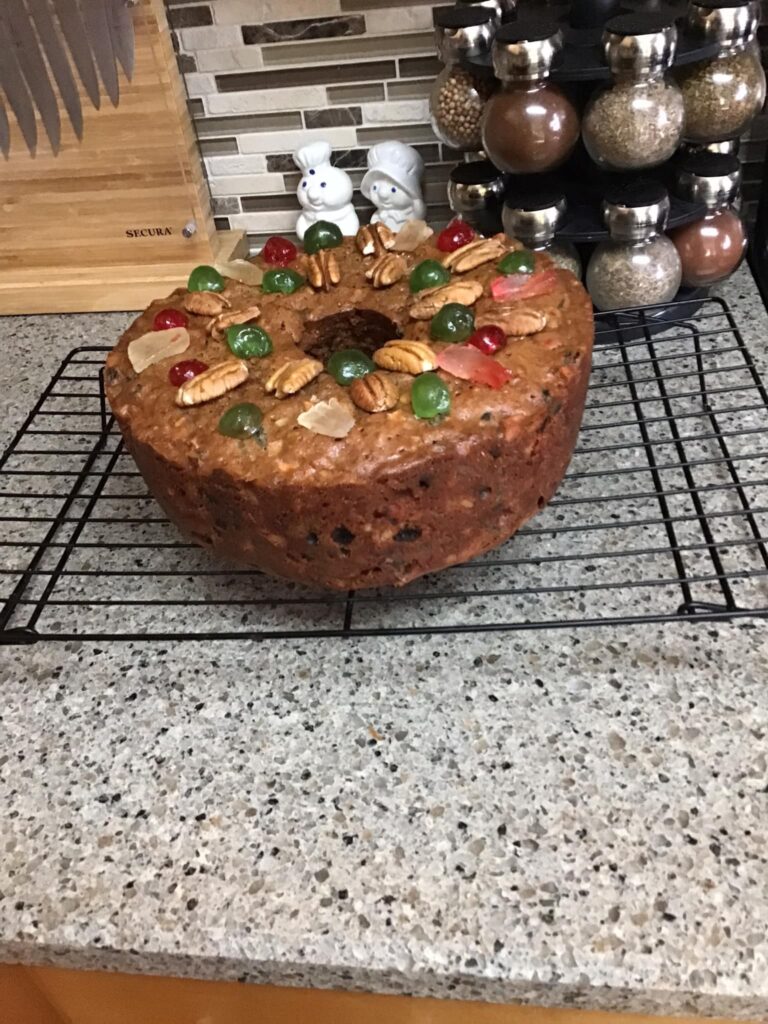 Bourbon-soaked fruitcake wrapped in cheesecloth for aging