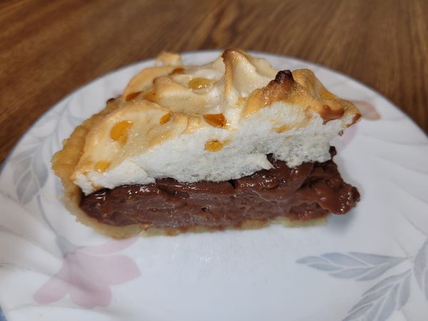 Homemade chocolate meringue pie with a crisp crust, velvety chocolate filling, and fluffy meringue topping