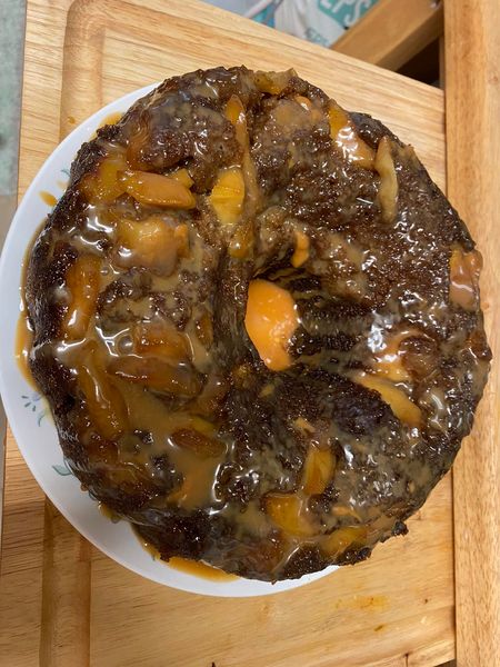 Side view of a caramel apple Bundt cake with dripping caramel glaze