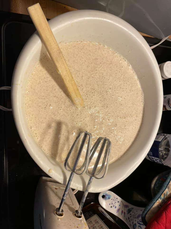 Eggs and milk being mixed in a bowl to make homemade eggnog