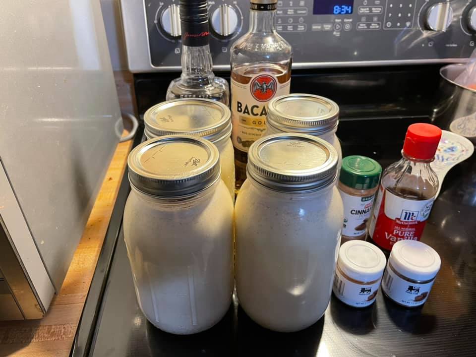 "Homemade eggnog stored in mason jars, chilled in the refrigerator."