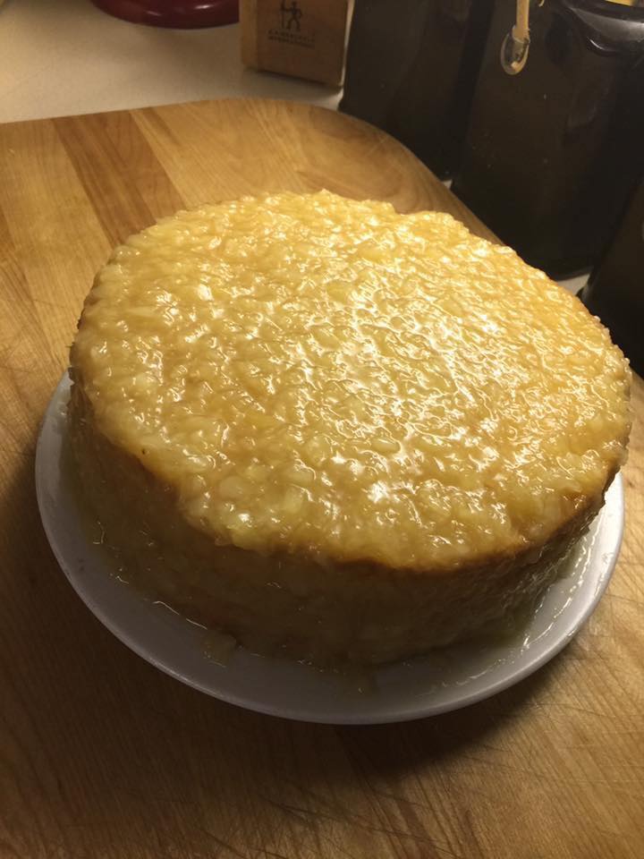 A two-layer cake generously coated with a golden pineapple glaze.