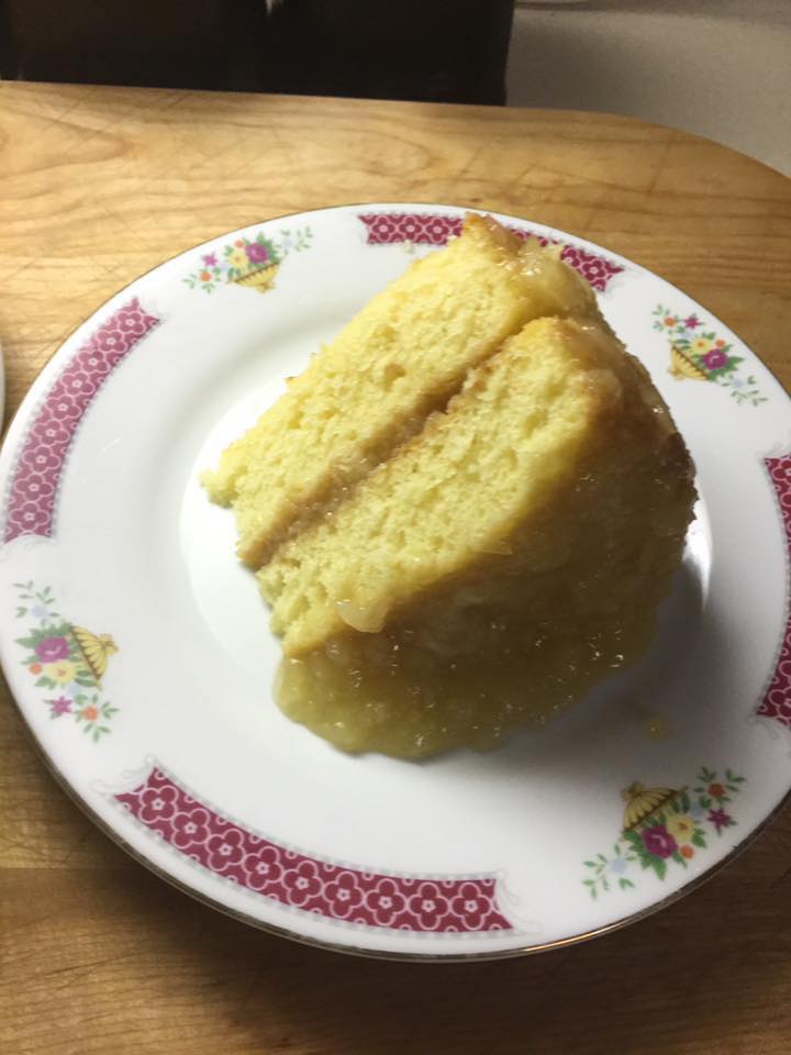 moist, homemade pineapple cake with a slice removed to show its soft layers.