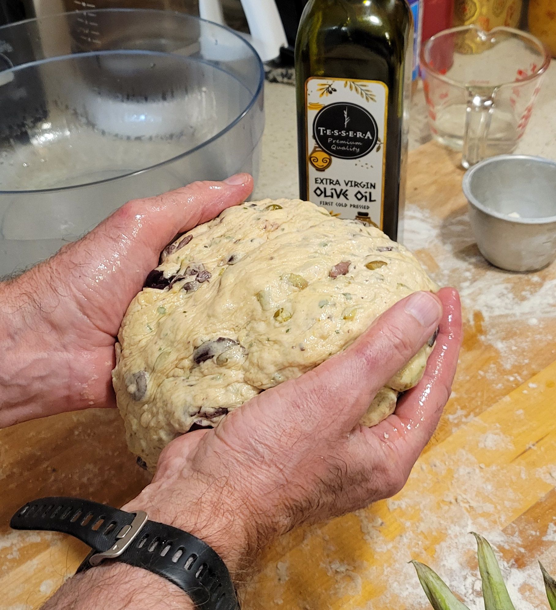 A dough ball on a floured board, ready to be shaped into loaves