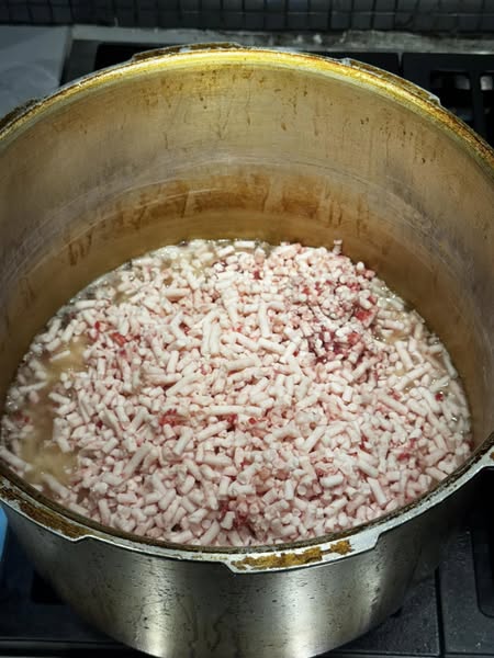 Ground beef suet added to a pressure cooker before rendering.