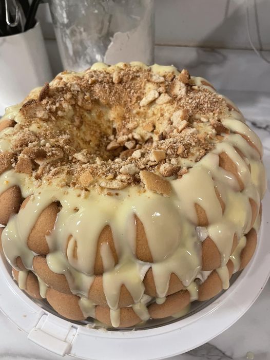 A moist banana pudding pound cake drizzled with vanilla pudding glaze and topped with crunchy vanilla wafers.