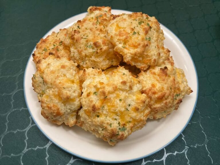 Golden brown cheddar biscuits on a plate, ready to eat