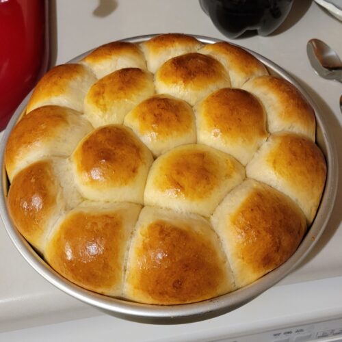 Freshly baked vintage dinner rolls in round pan, golden brown and fluffy