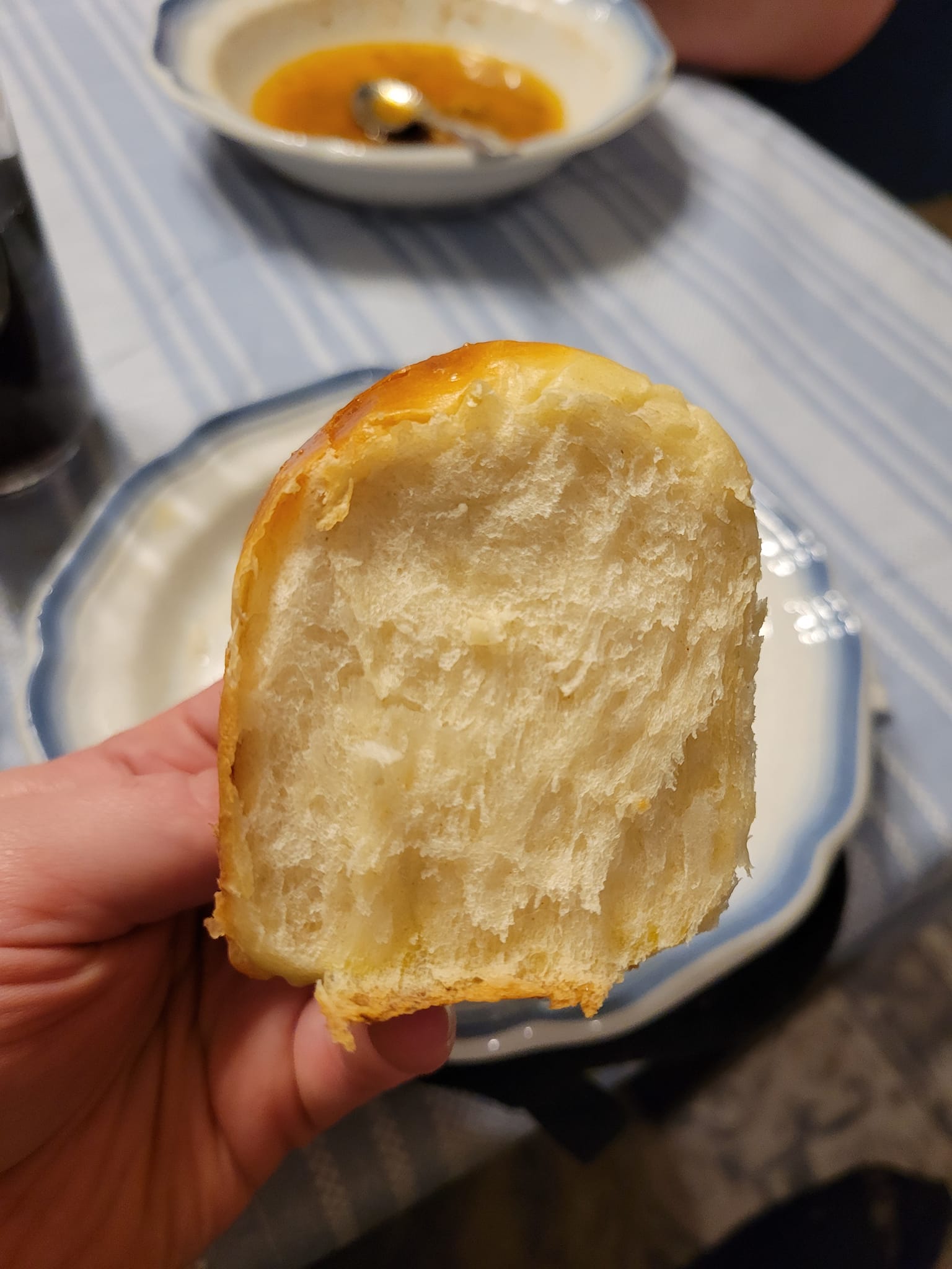 Soft interior of a fluffy dinner roll pulled in half