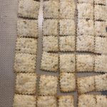 Homemade sourdough discard crackers cut into squares on silicone baking mat