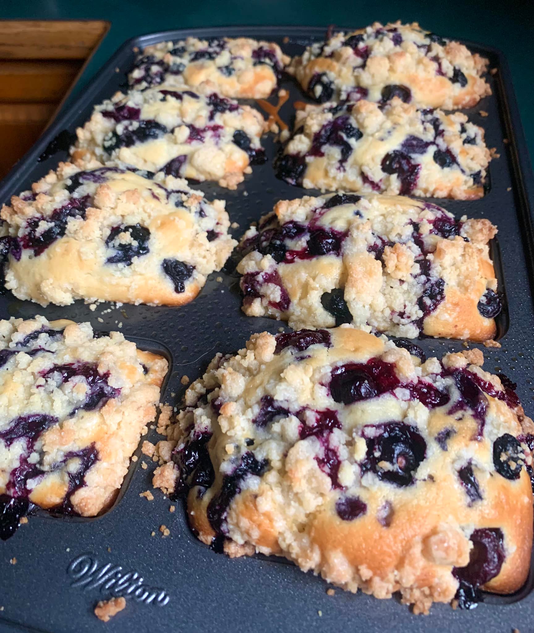 Golden blueberry muffin loaf with juicy berries and crunchy topping fresh out of the oven.