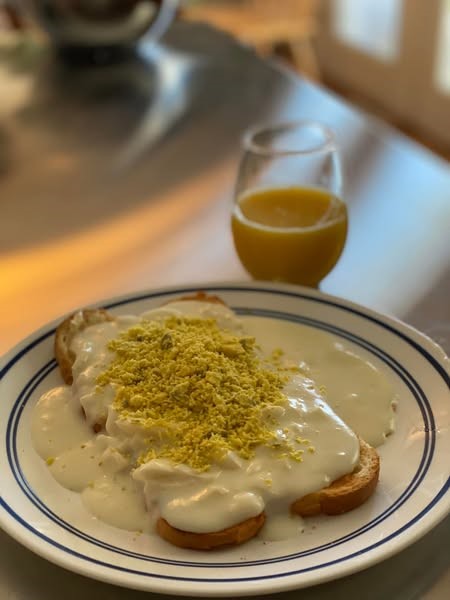Overhead shot of two plates of eggs à la goldenrod on a kitchen table, ready to serve]