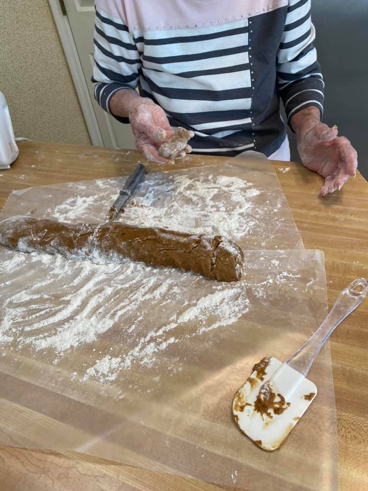 slicing old fashioned gingerbread cookies log